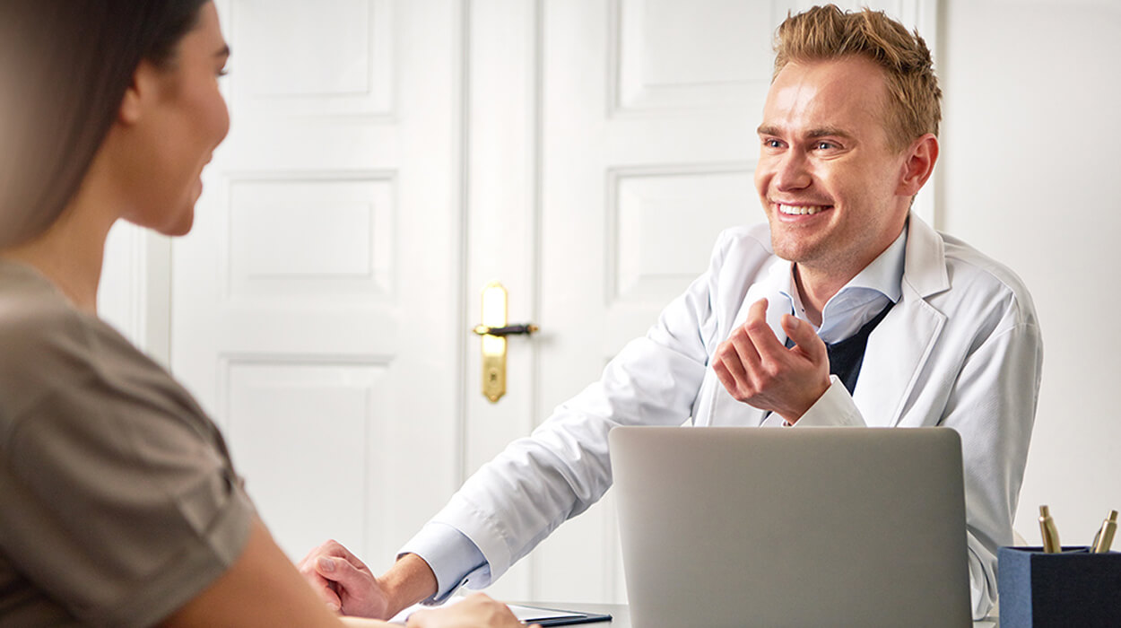 Practitioner working with a client using medical spa EMR software