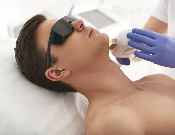Medical practitioner working on male client at medical spa