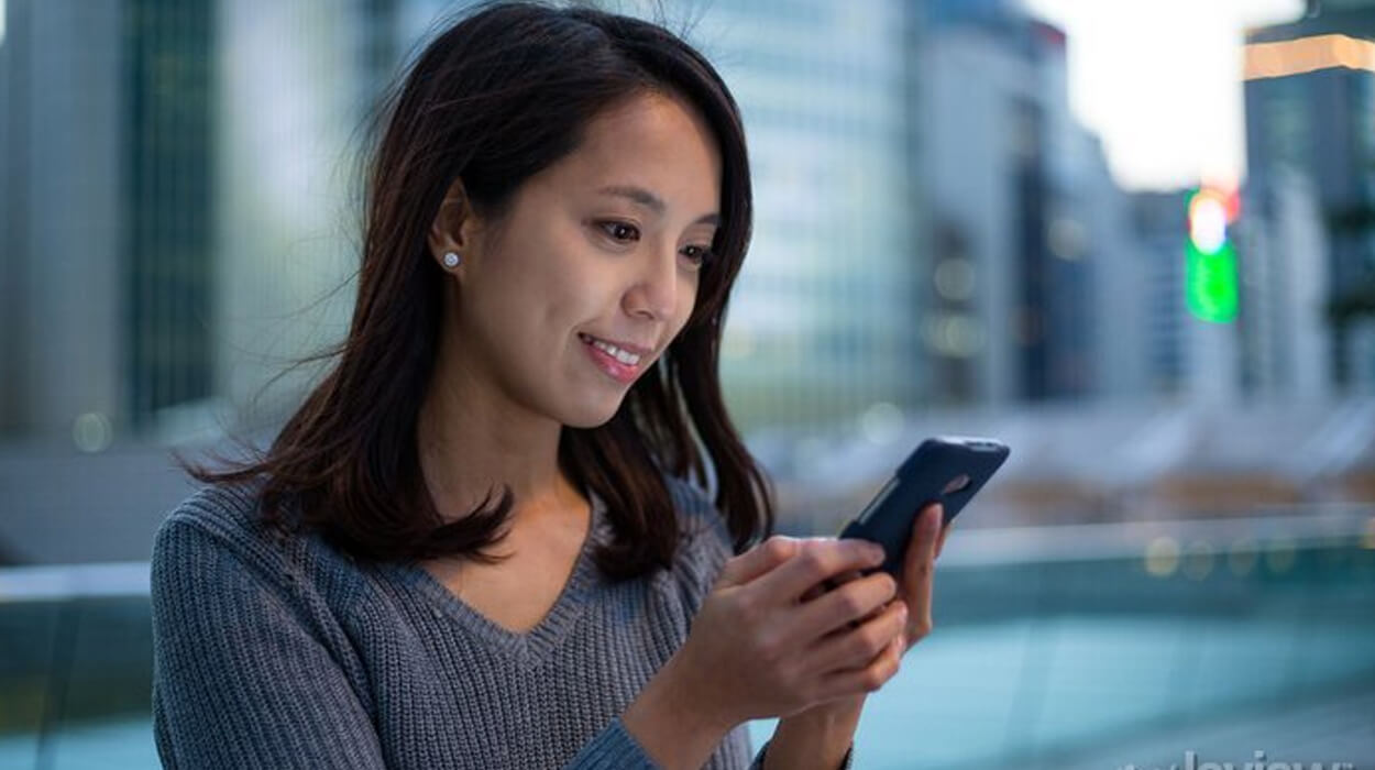Pretty woman looking at her phone or social media