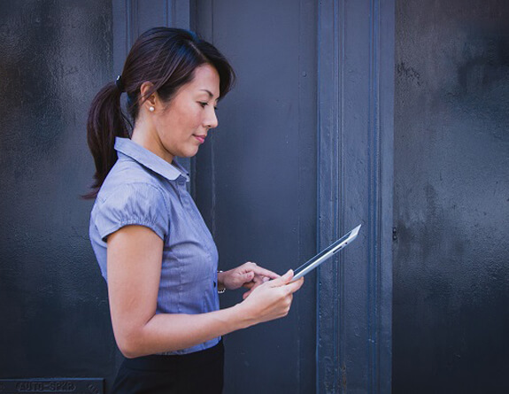 Spa Receptionist using a tablet.