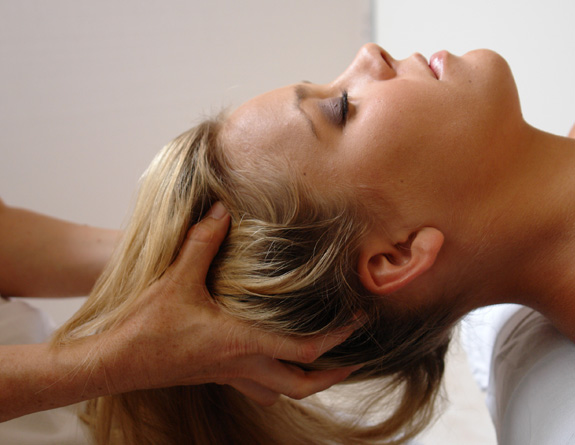Someone enjoying a scalp massage found using aesthetic clinic software.
