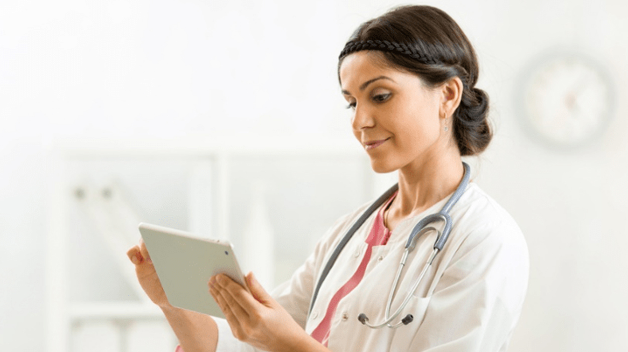 Female doctor holding tablet in medical aesthetics practice.