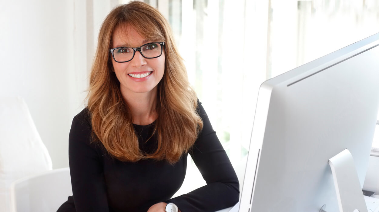 Medspa professional sitting at a computer.