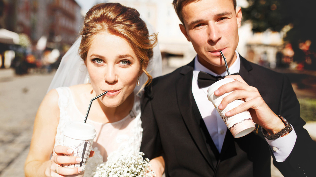 Groom and his bride confidently being photographed on their wedding day after receiving medspa treatments.