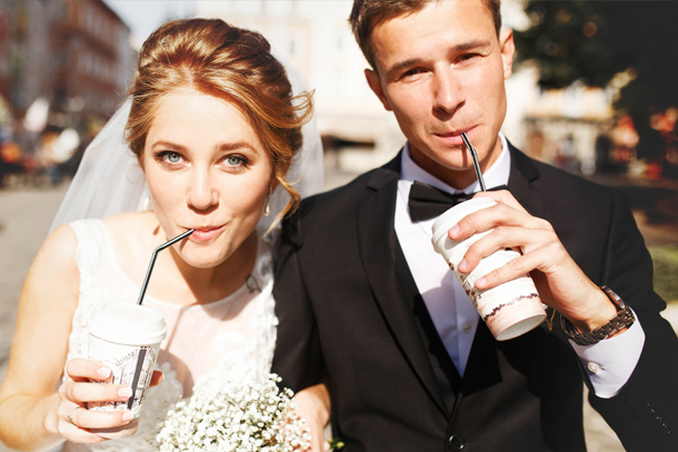 Groom and his bride confidently being photographed on their wedding day after receiving medspa treatments.