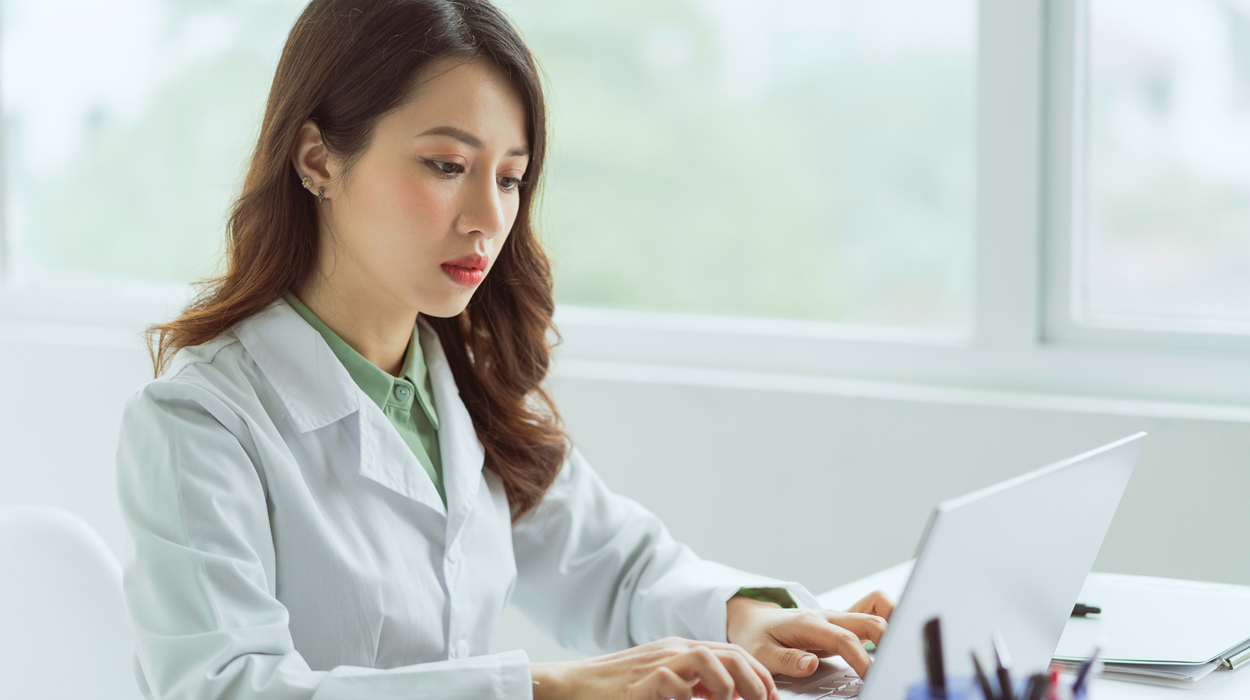 Medical Professial logging into her computer