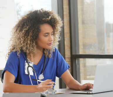 Nurse practitioner using medspa software on the computer.