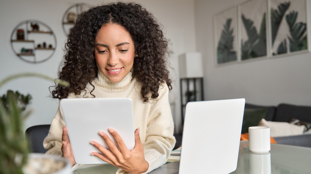 Small spa business owner using spa management software on multiple devices to manage appointments and client bookings