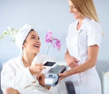 Client is paying using payment device connected to medical spa software.