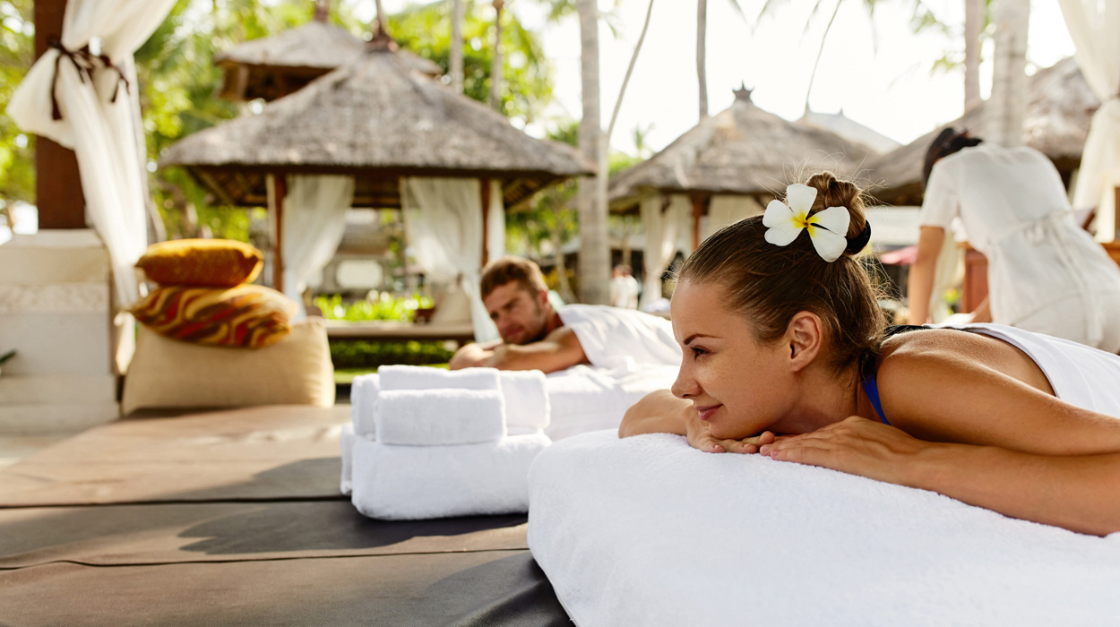 Couple having relaxing concierge massage service booked through aesthetic clinic software