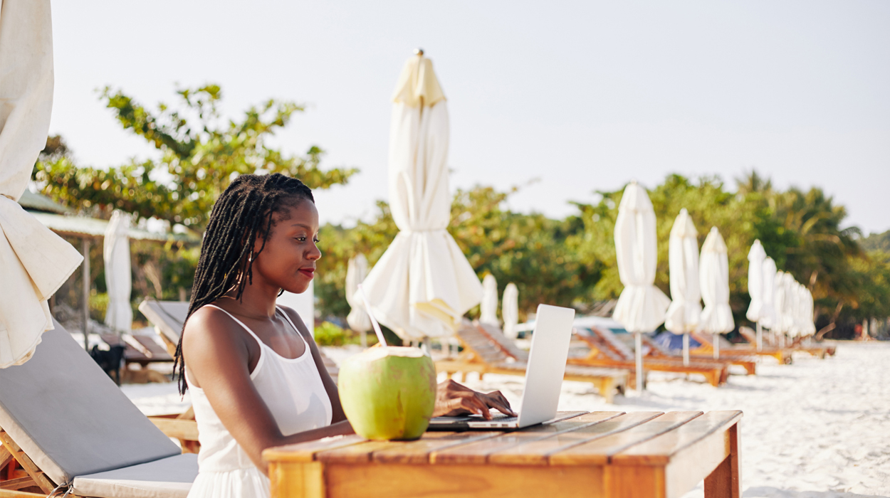 Medspa owner using spa management software on the beach