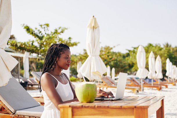 Medspa owner using spa management software on the beach