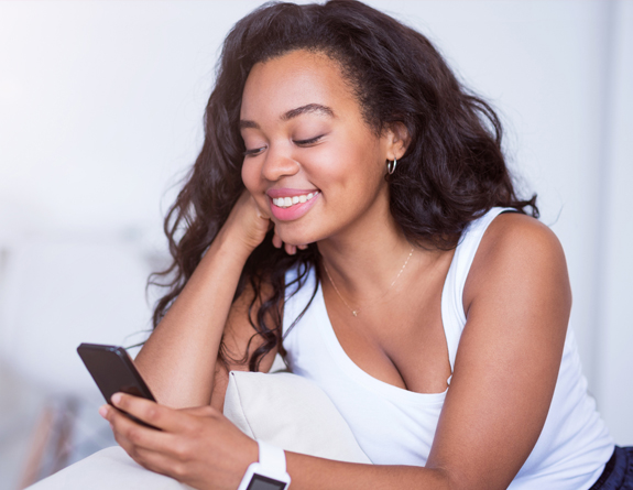 Esthetician using best medical spa software on mobile device