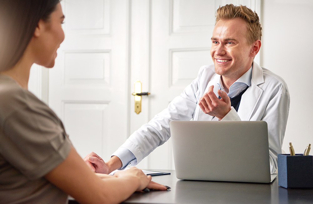 Practitioner working with a client using medical spa EMR software