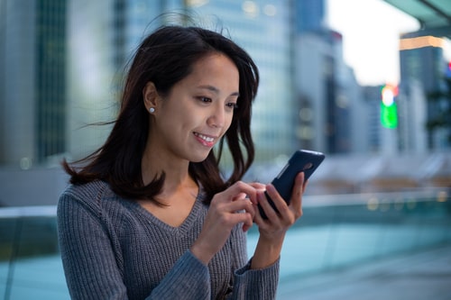 Pretty woman looking at her phone or social media