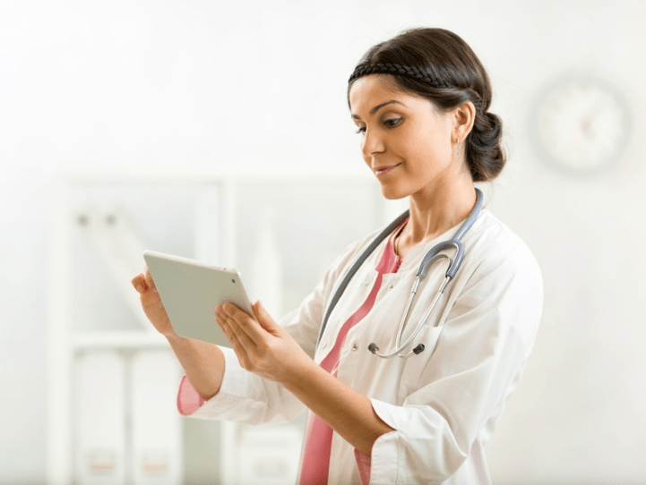Female doctor holding tablet in medical aesthetics practice.