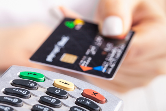 Person paying with a credit card after a medical spa treatment.