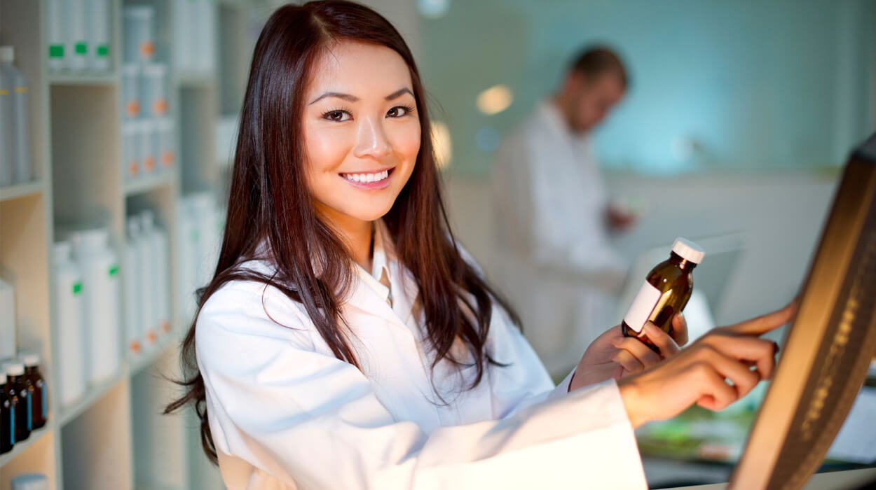 A pharmacist on a computer