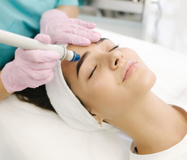 A medspa client receiving microdermabrasion.