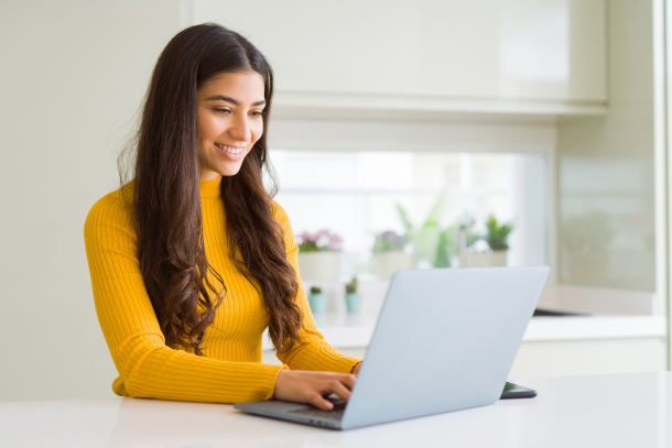 Med spa owner reviewing lead generation strategies on computer using medical spa software dashboard