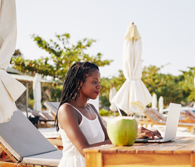Medspa owner using spa management software on the beach