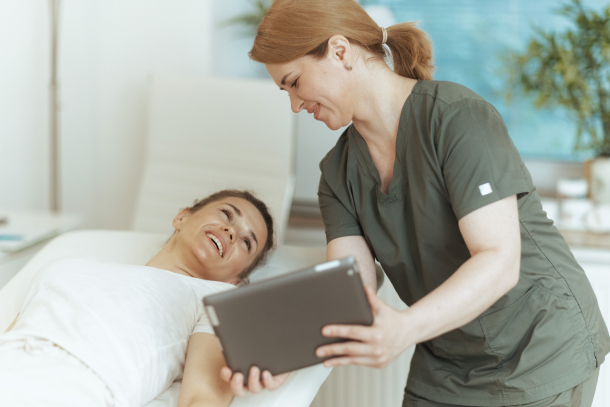 Massage therapist using medical spa software to schedule their next appointment.