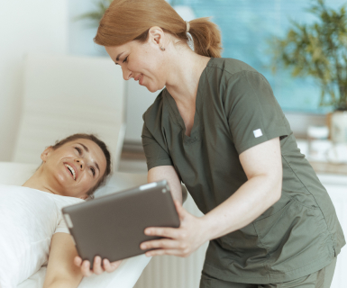 Massage therapist using medical spa software to schedule their next appointment.